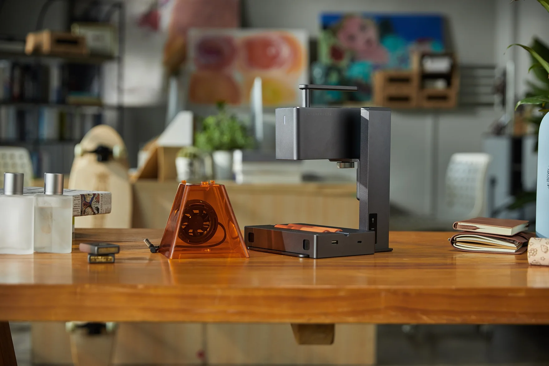 A LaserPecker engraver set up on a workbench in a craft studio